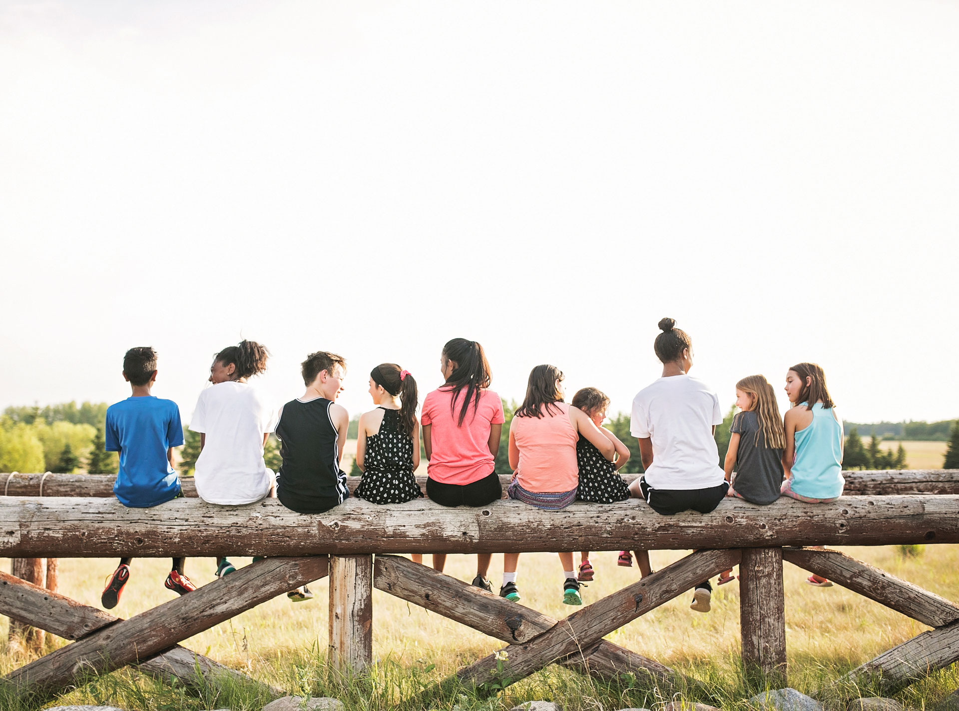 Several students sitting together in a line having conversations with each other